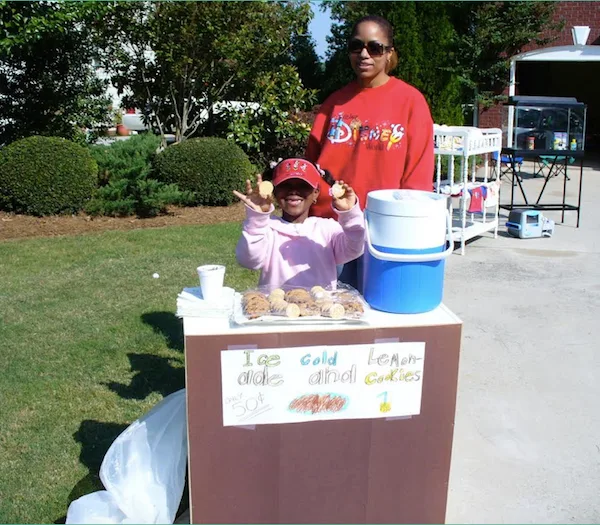 Jordan as a child selling cookies at a stand in 2008